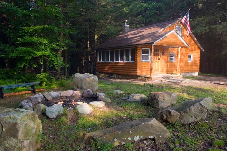 This secluded logged vacation cabin has a huge hottub, campfire and amenities. Enjoy hiking on our trails or on the 1,100 acres of pure State Game Lands that touch our property.